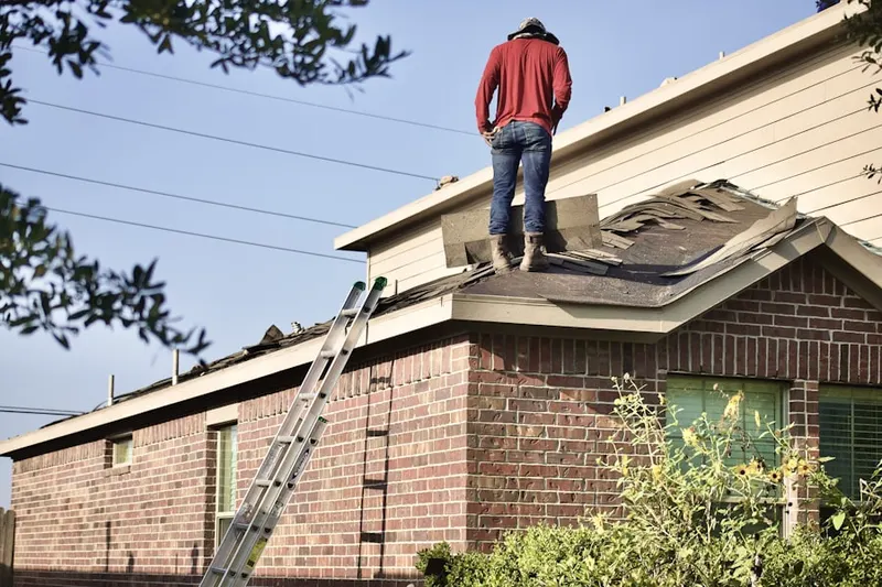 Professional roofer working on a residential roof in Palos Verdes Peninsula